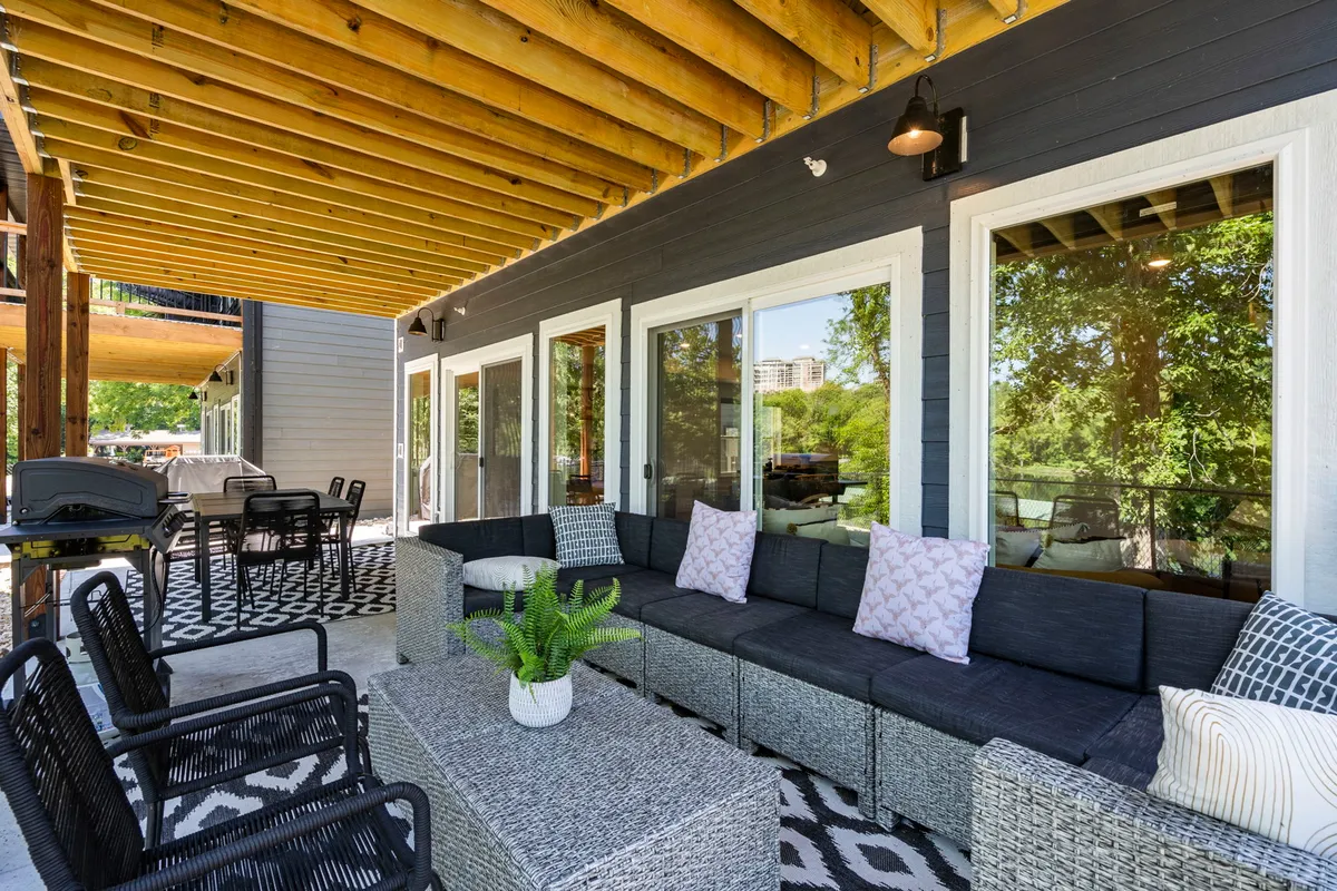 A spacious patio with a comfortable seating area and a modern outdoor gas grill, offering sweeping landscape views. The setup is ideal for al fresco dining, barbecues, and gathering with friends or family after a day of adventure.